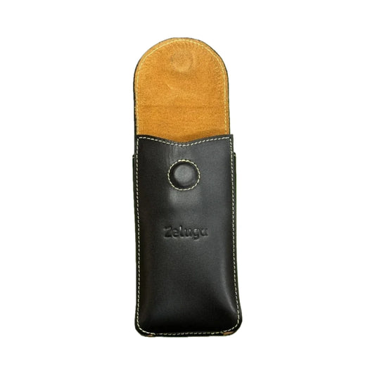 Funda de teléfono de cuero negra con tapa superior color miel y anillo metálico